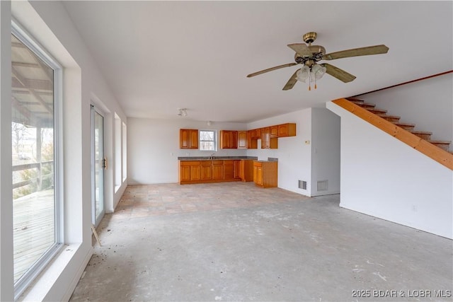 unfurnished living room featuring ceiling fan