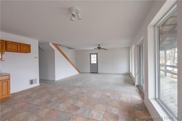 unfurnished living room with ceiling fan