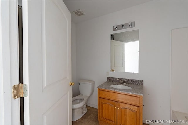 bathroom featuring vanity and toilet