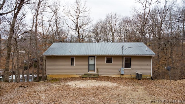 back of property featuring central AC