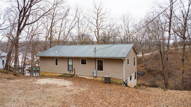 rear view of property featuring central AC