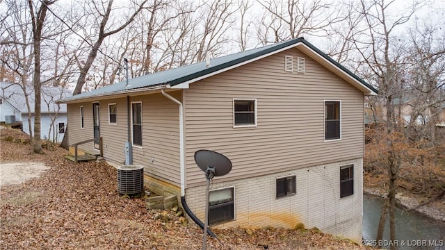 view of side of home with central air condition unit