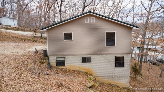 view of side of property with central air condition unit