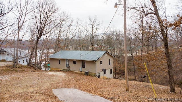 rear view of property featuring central AC