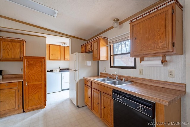 kitchen featuring sink, black dishwasher, white refrigerator, ornamental molding, and washing machine and clothes dryer