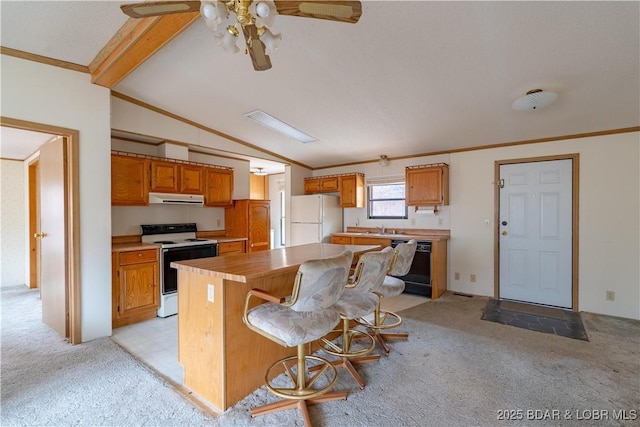 kitchen with vaulted ceiling with beams, light carpet, a kitchen breakfast bar, a kitchen island, and white appliances