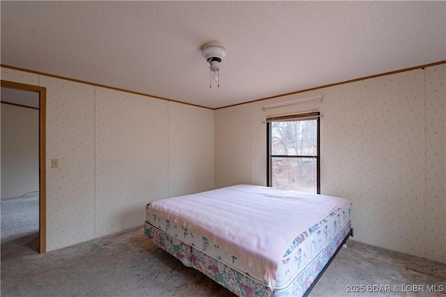 unfurnished bedroom featuring ornamental molding, carpet flooring, and a textured ceiling