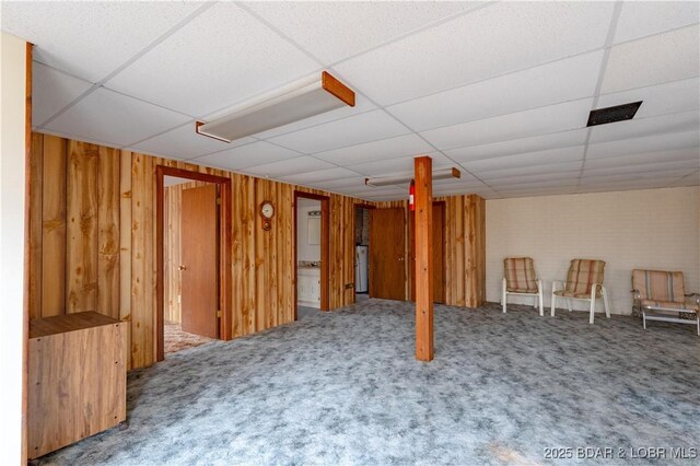 3975 Chelsie Rd, Laurie, MO 65079 - finished basement with carpet flooring, a paneled ceiling, and wood walls