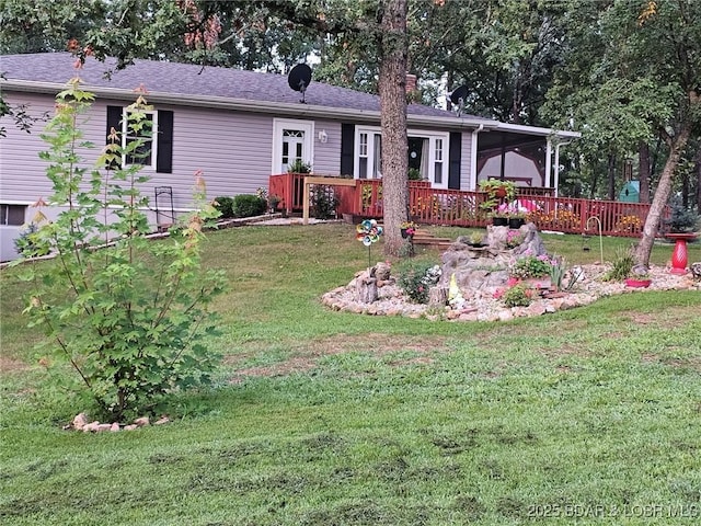 ranch-style house with a front lawn and a deck