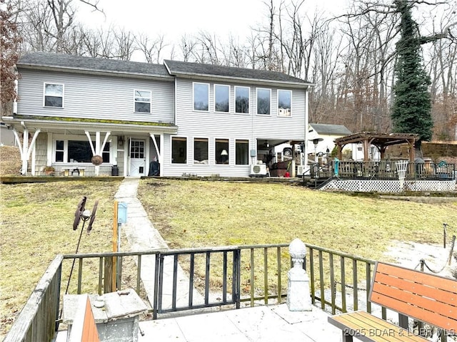 rear view of house with a gazebo and a lawn