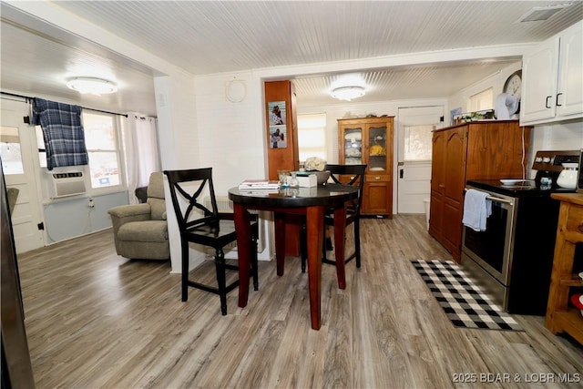 dining room featuring cooling unit, wood ceiling, and light wood-type flooring