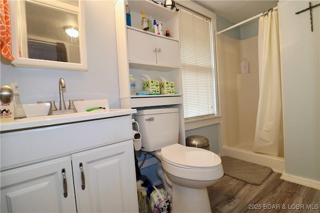 bathroom featuring vanity, hardwood / wood-style floors, toilet, and a shower with shower curtain