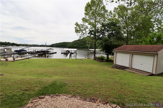 980 Laura Hufferd Rd, Roach, MO 65787 - view of grassy yard with a water view, a dock, a detached garage, and an outdoor structure