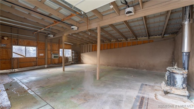 garage with a garage door opener and a wall mounted AC