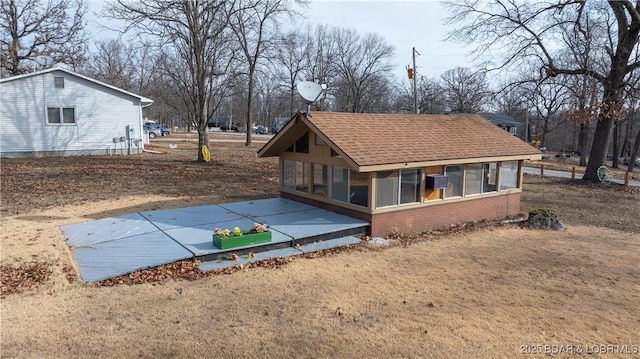 view of side of home featuring a sunroom