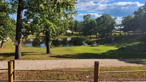 view of property's community with a yard and a water view