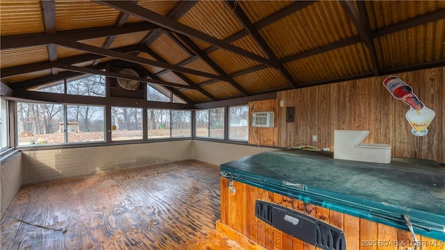 unfurnished sunroom featuring electric panel, vaulted ceiling, and an AC wall unit