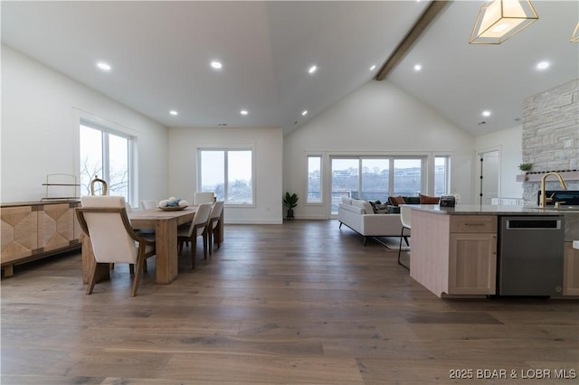 dining room featuring dark hardwood / wood-style flooring, sink, high vaulted ceiling, and beamed ceiling