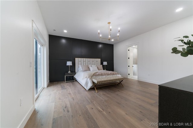 bedroom featuring a chandelier and light hardwood / wood-style flooring