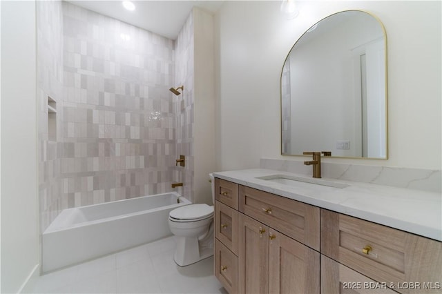 full bathroom with vanity, tile patterned flooring, toilet, and tiled shower / bath