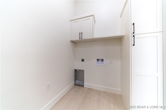 laundry room with cabinets, hookup for an electric dryer, light hardwood / wood-style floors, and hookup for a washing machine