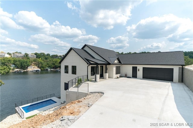 modern farmhouse style home with a water view and a garage