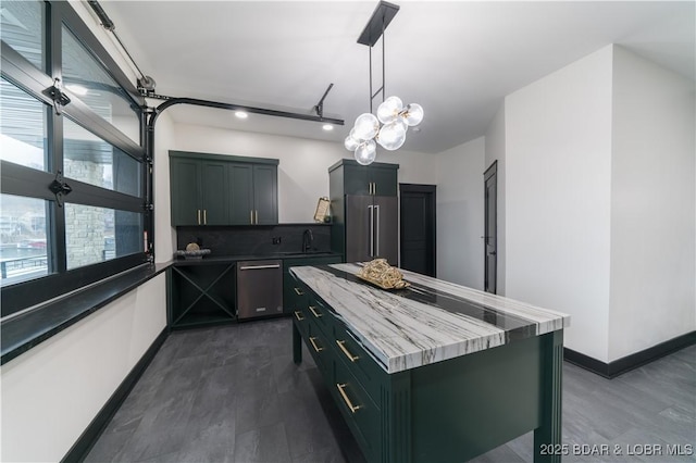 kitchen with sink, decorative light fixtures, a kitchen island, stainless steel appliances, and backsplash