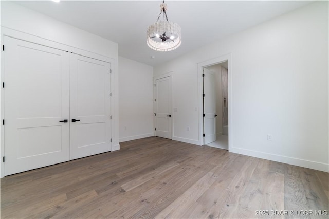 interior space with a notable chandelier and light hardwood / wood-style flooring