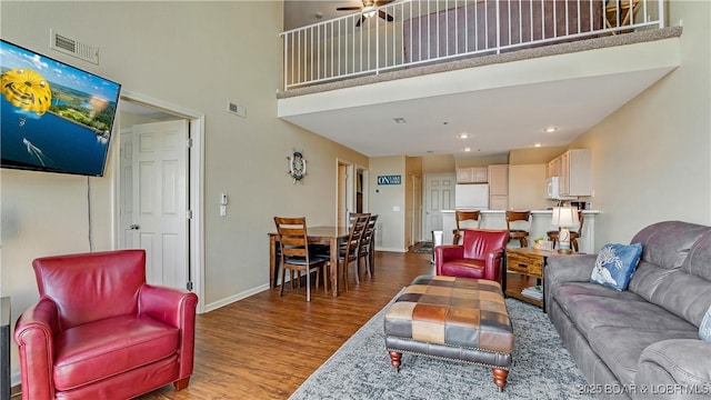 living room featuring hardwood / wood-style flooring and a high ceiling