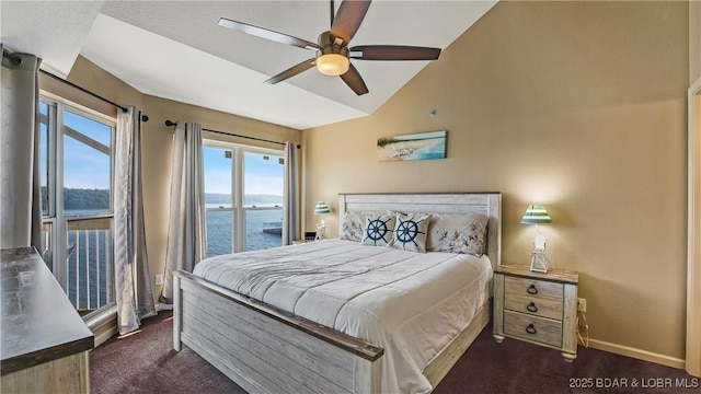 bedroom with lofted ceiling, dark colored carpet, access to exterior, ceiling fan, and a water view