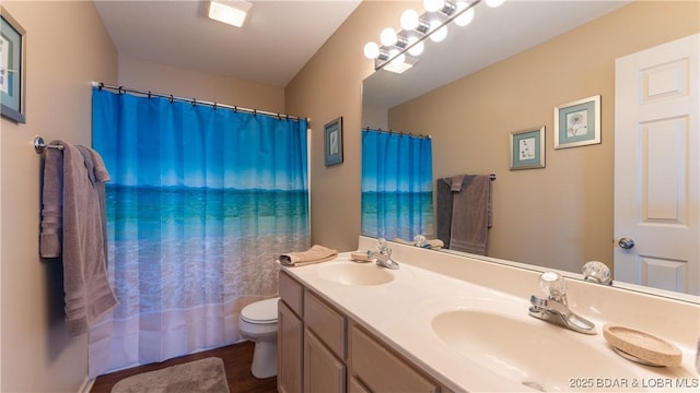 bathroom with a shower with shower curtain, vanity, toilet, and hardwood / wood-style floors