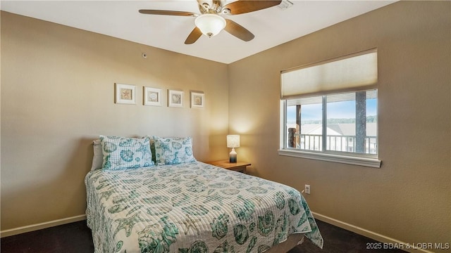 bedroom featuring ceiling fan and dark colored carpet