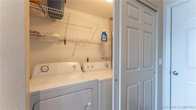 clothes washing area featuring independent washer and dryer