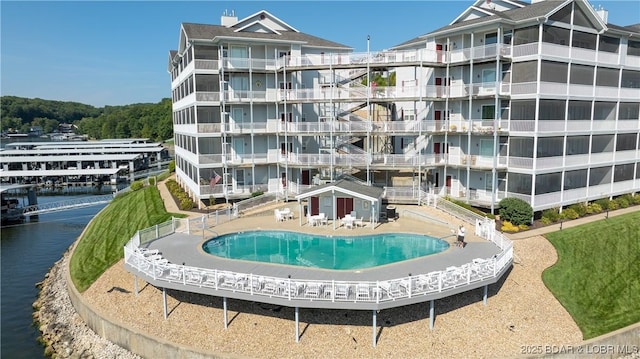 view of property featuring a water view and a community pool