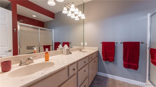 bathroom with vanity and a shower with door