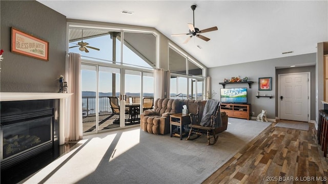 living room featuring carpet floors, high vaulted ceiling, and ceiling fan