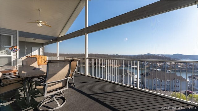 exterior space featuring a water and mountain view and ceiling fan