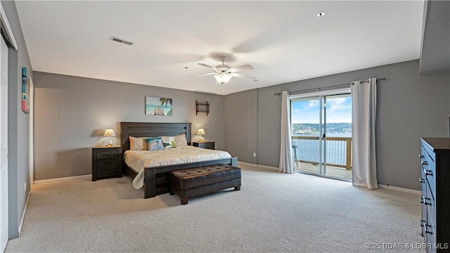 carpeted bedroom featuring a water view, access to outside, and ceiling fan