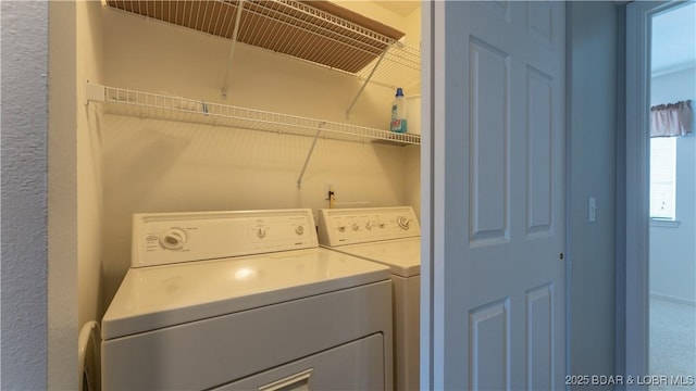 laundry room with washing machine and clothes dryer