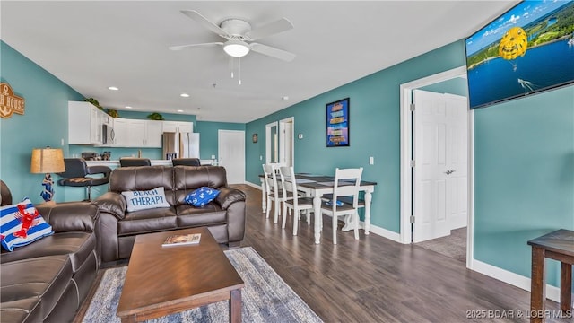 living room featuring dark hardwood / wood-style flooring and ceiling fan