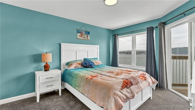 carpeted bedroom featuring access to outside and a water view