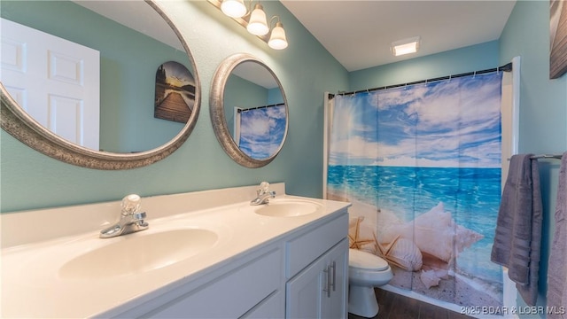 bathroom with a shower with curtain, vanity, and toilet