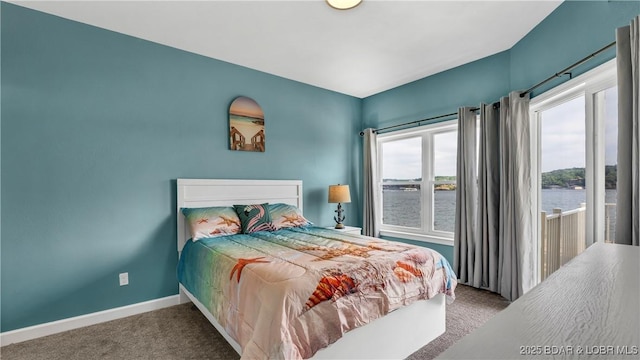 bedroom featuring carpet flooring and a water view