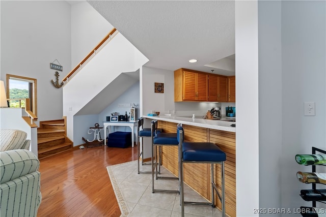 kitchen featuring a textured ceiling and light wood-type flooring