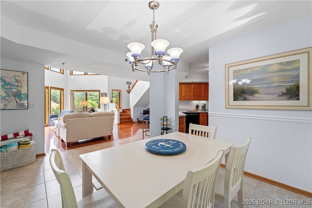 tiled dining space featuring a notable chandelier