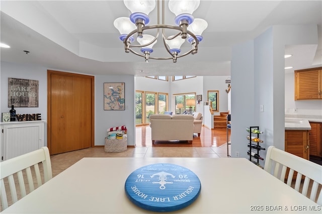 dining space featuring a notable chandelier and light tile patterned floors