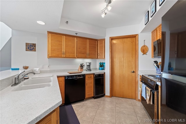 kitchen featuring sink, track lighting, black appliances, and light tile patterned flooring