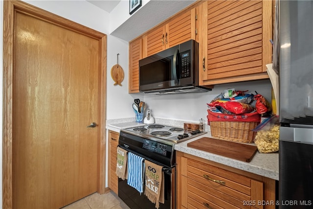 kitchen featuring light tile patterned floors and black appliances