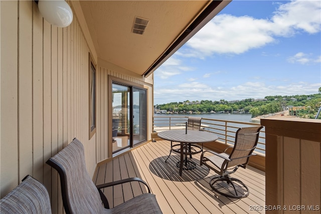 wooden terrace with a water view