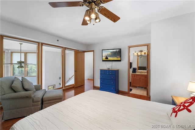 bedroom featuring ceiling fan, ensuite bath, and light hardwood / wood-style floors